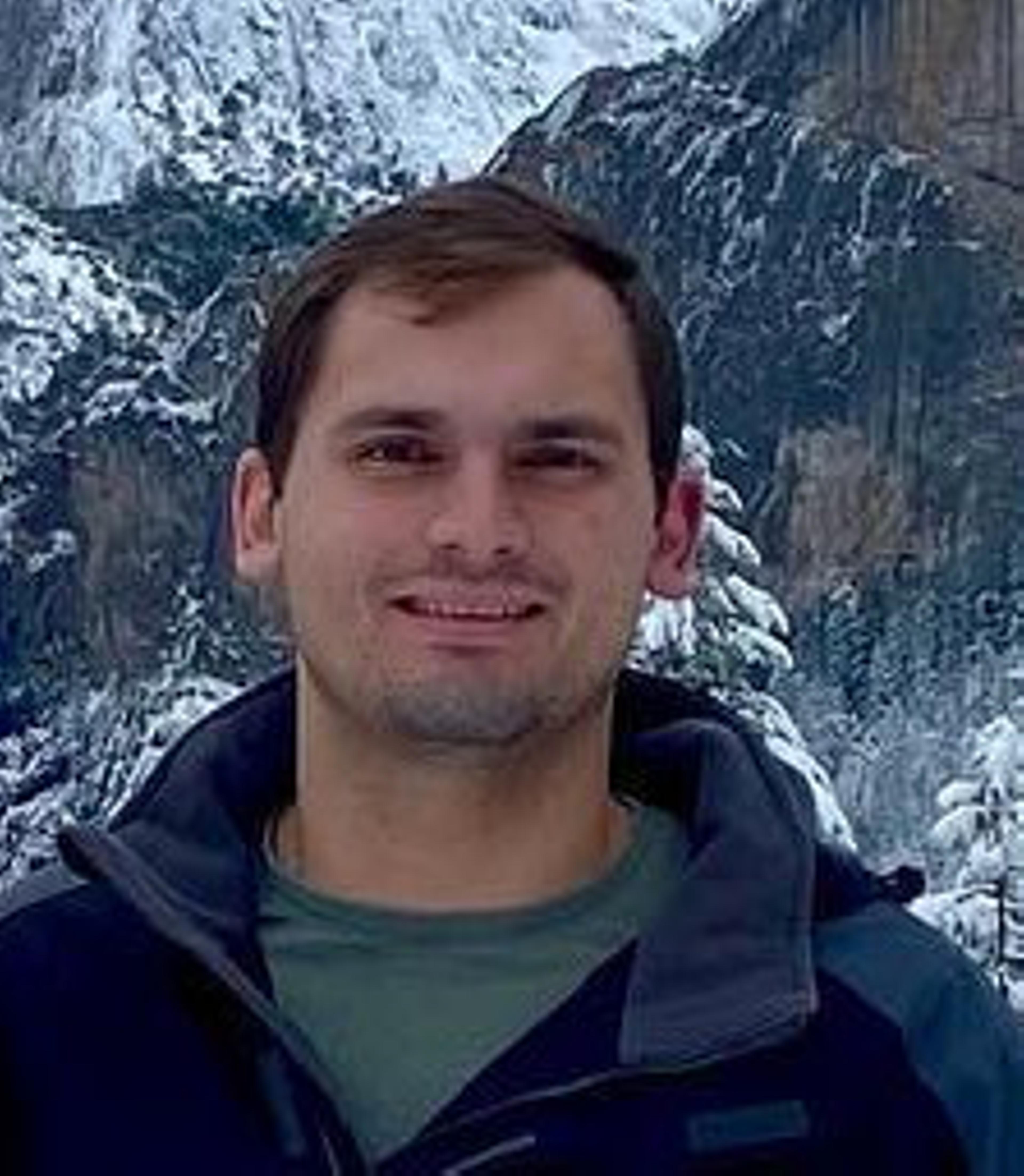 Portrait of Mitchell Hornsby standing in front of a snowy landscape at Yosemite National Park.